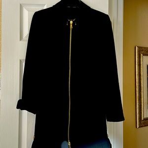 Long black zippered suit jacket. Can also be work as a dress.  Zipper  details.